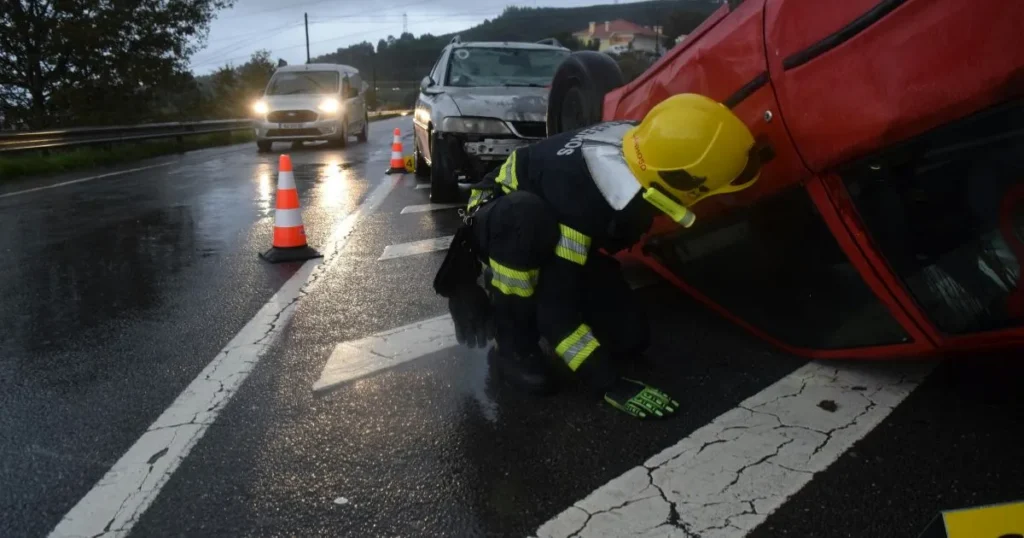 Firefighter helping a victim of a car crash out of their car